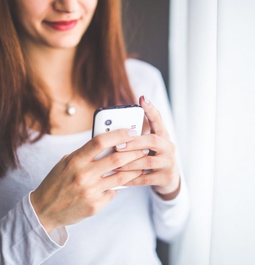 close-up-portrait-of-a-young-woman-typing-a-text-message-on-6400